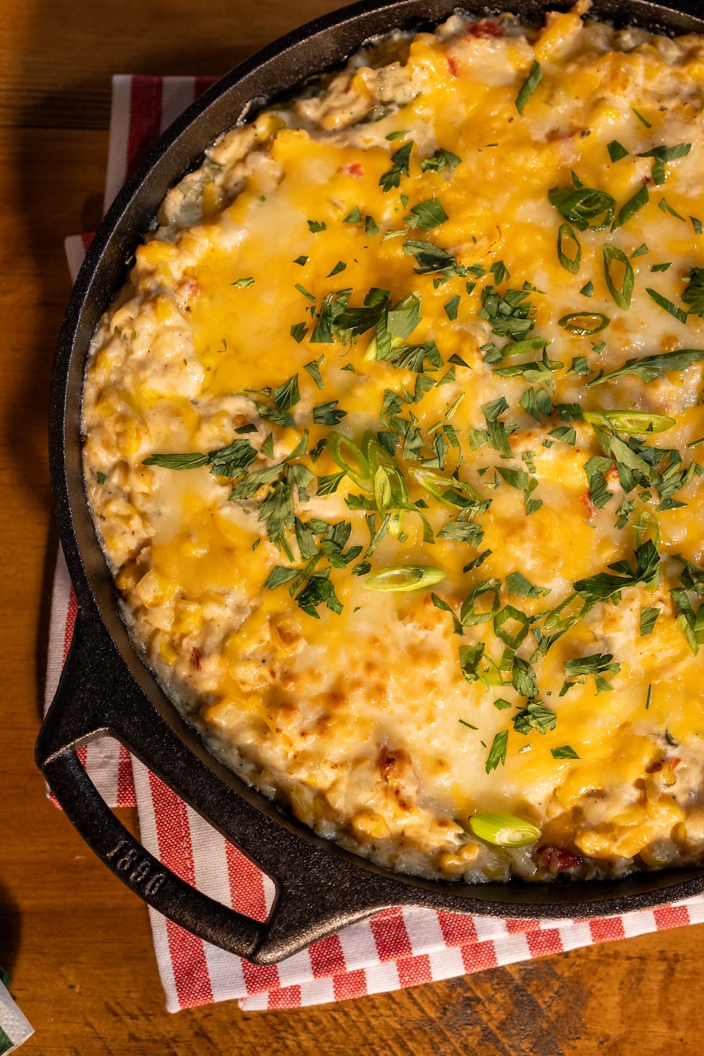 close up image of buffalo chicken dip in a cast iron skillet