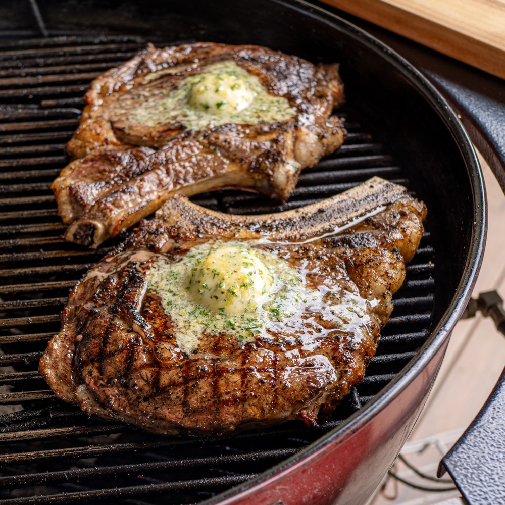 Grilled ribeye with compound butter on the grill 