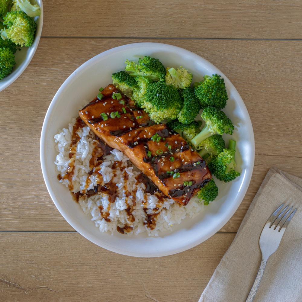 Teriyaki salmon and broccoli in a white bowl