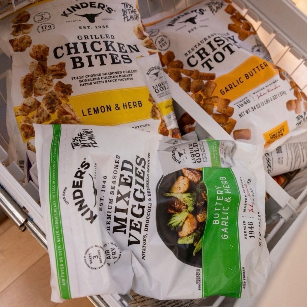 Bags of frozen veggies, tots, and chicken bites in the freezer