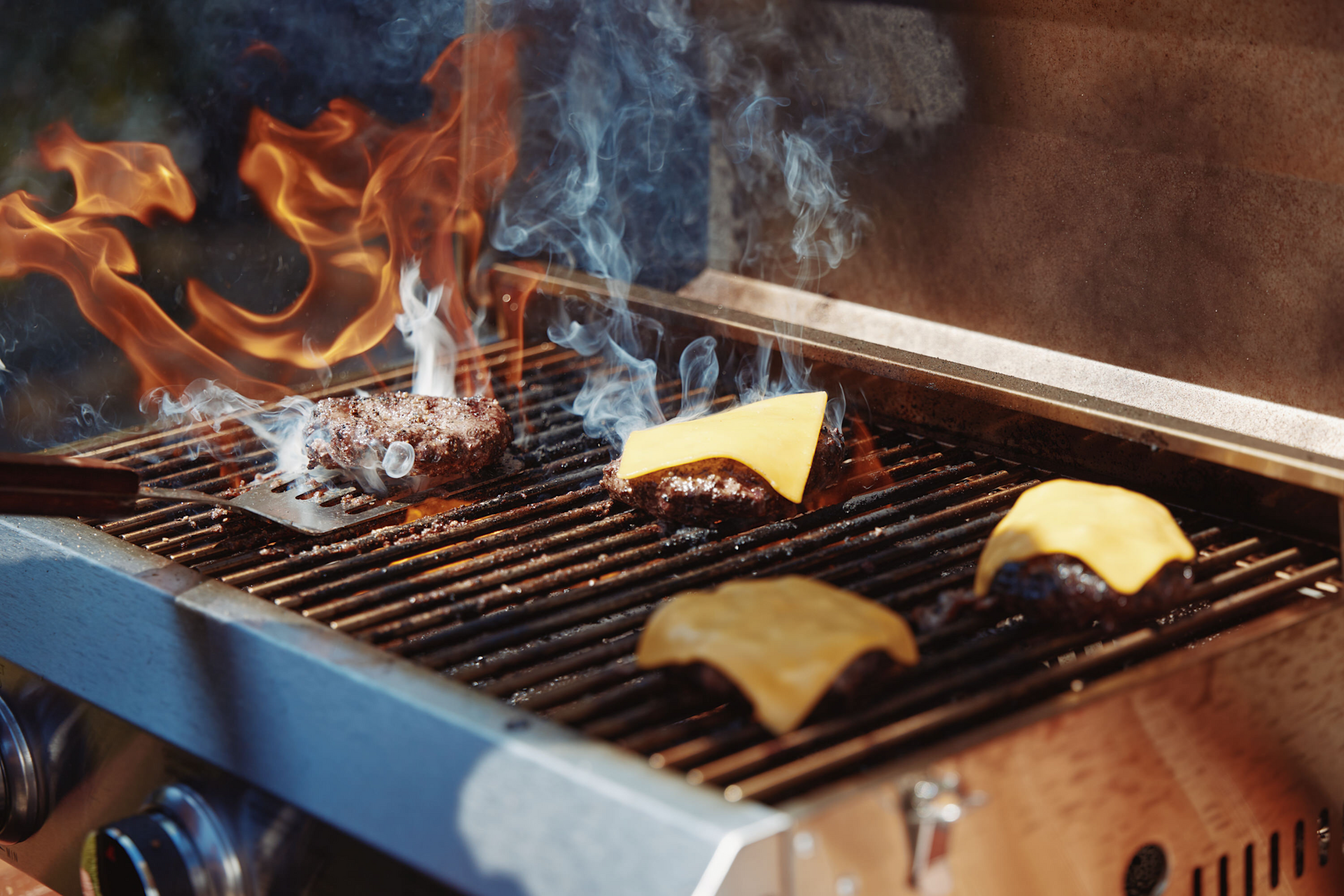 Burgers on the grill with flames