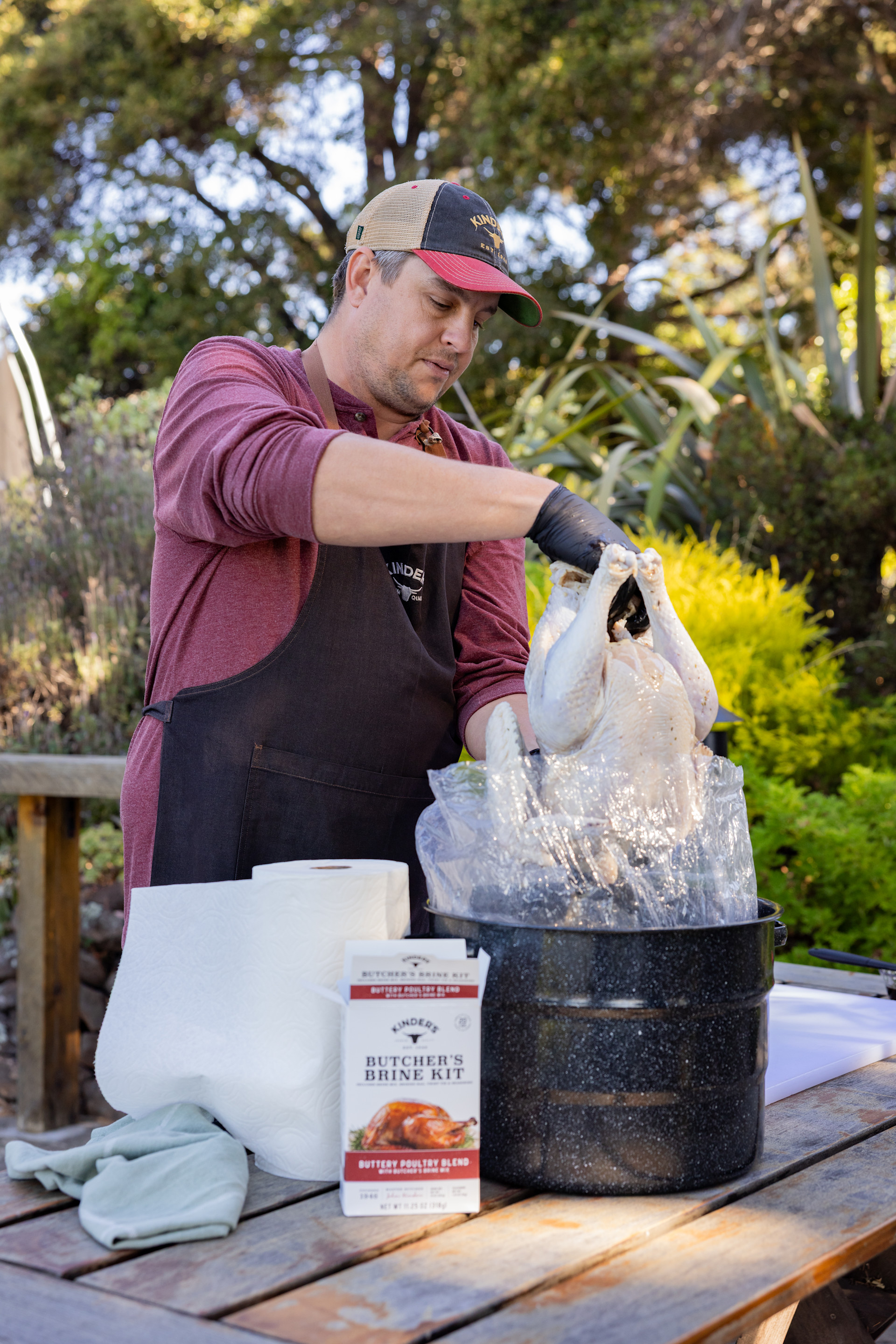 man brining a turkey with butcher's brine kit