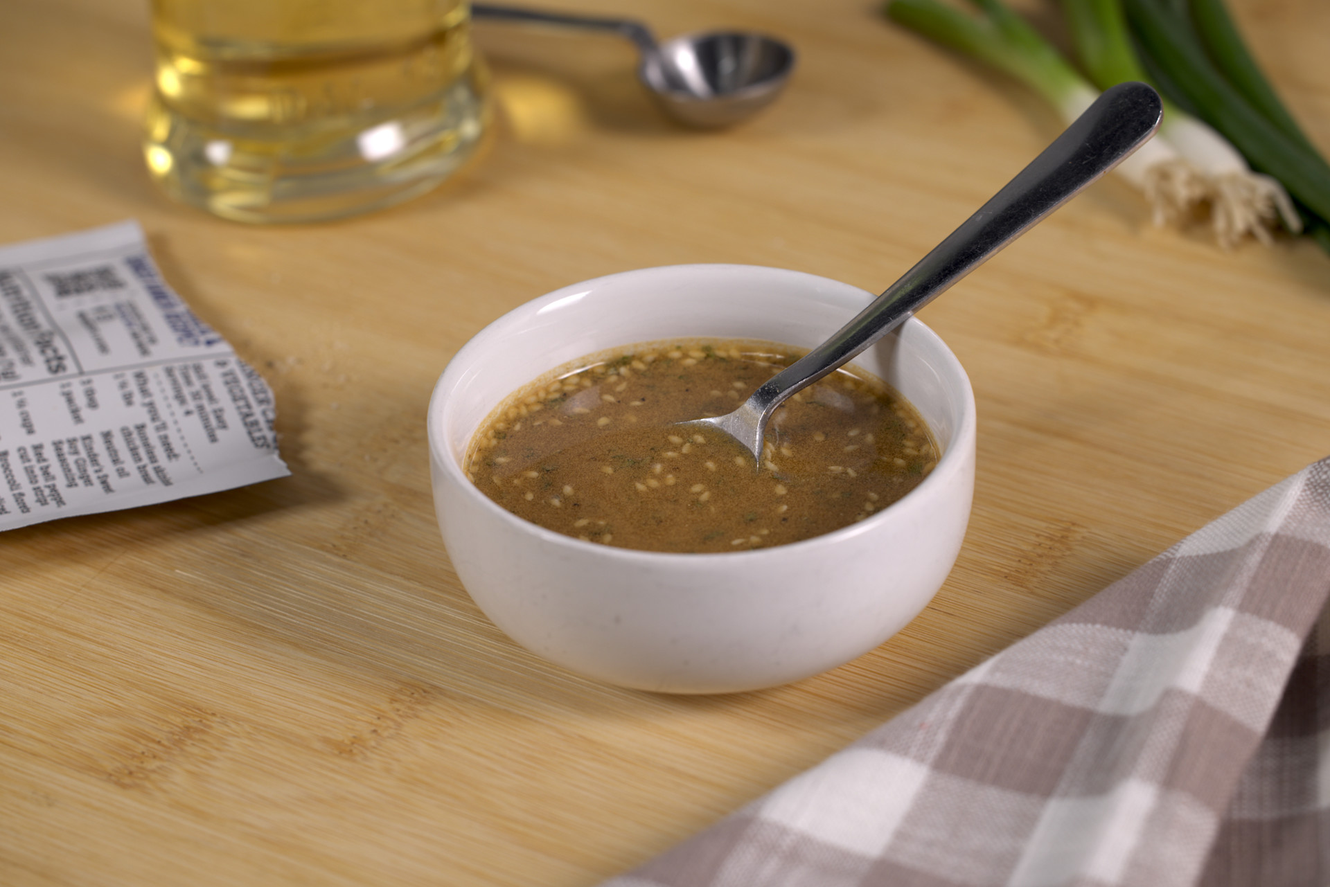 Sweet Soy Ginger Marinade in a white bowl with a spoon