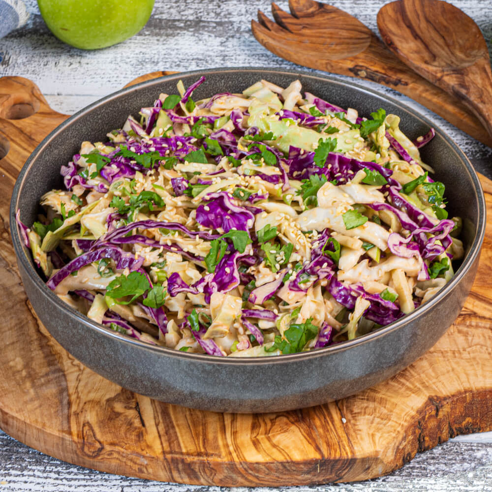 Bowl of coleslaw with sweet and spicy korean sauce