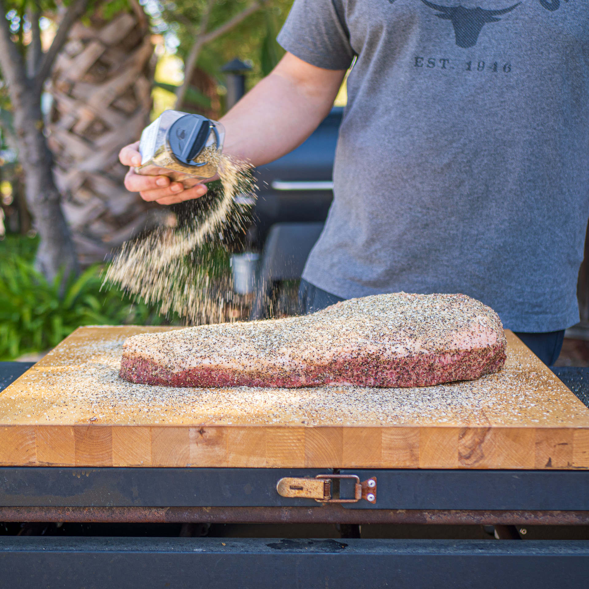 prepping brisket with seasoning