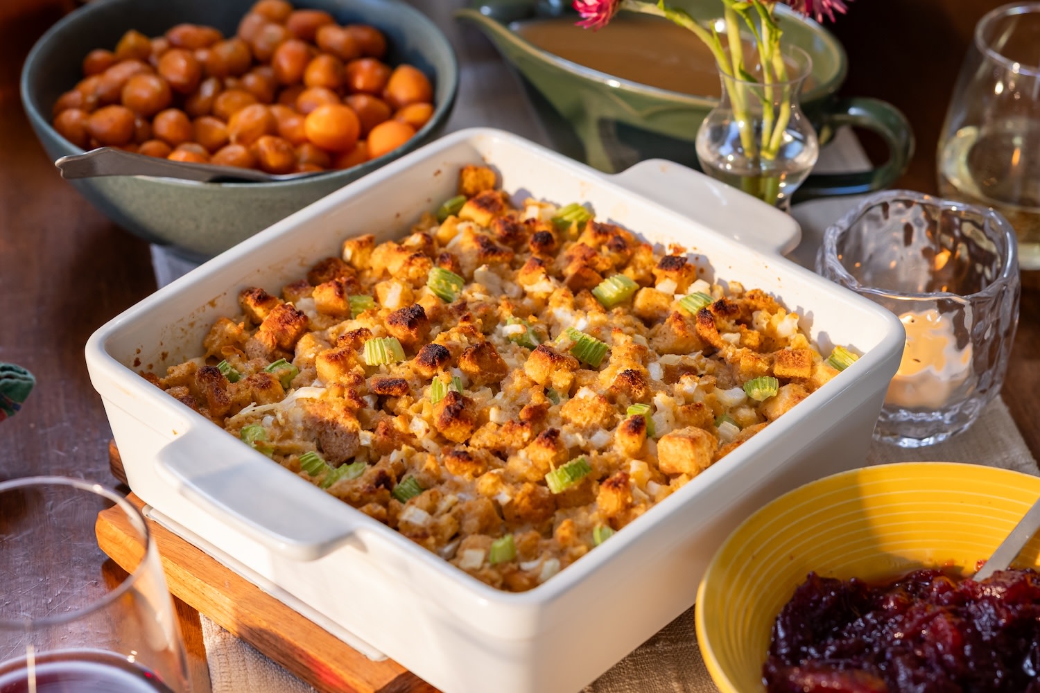 stuffing in a white casserole dish on a thanksgiving table
