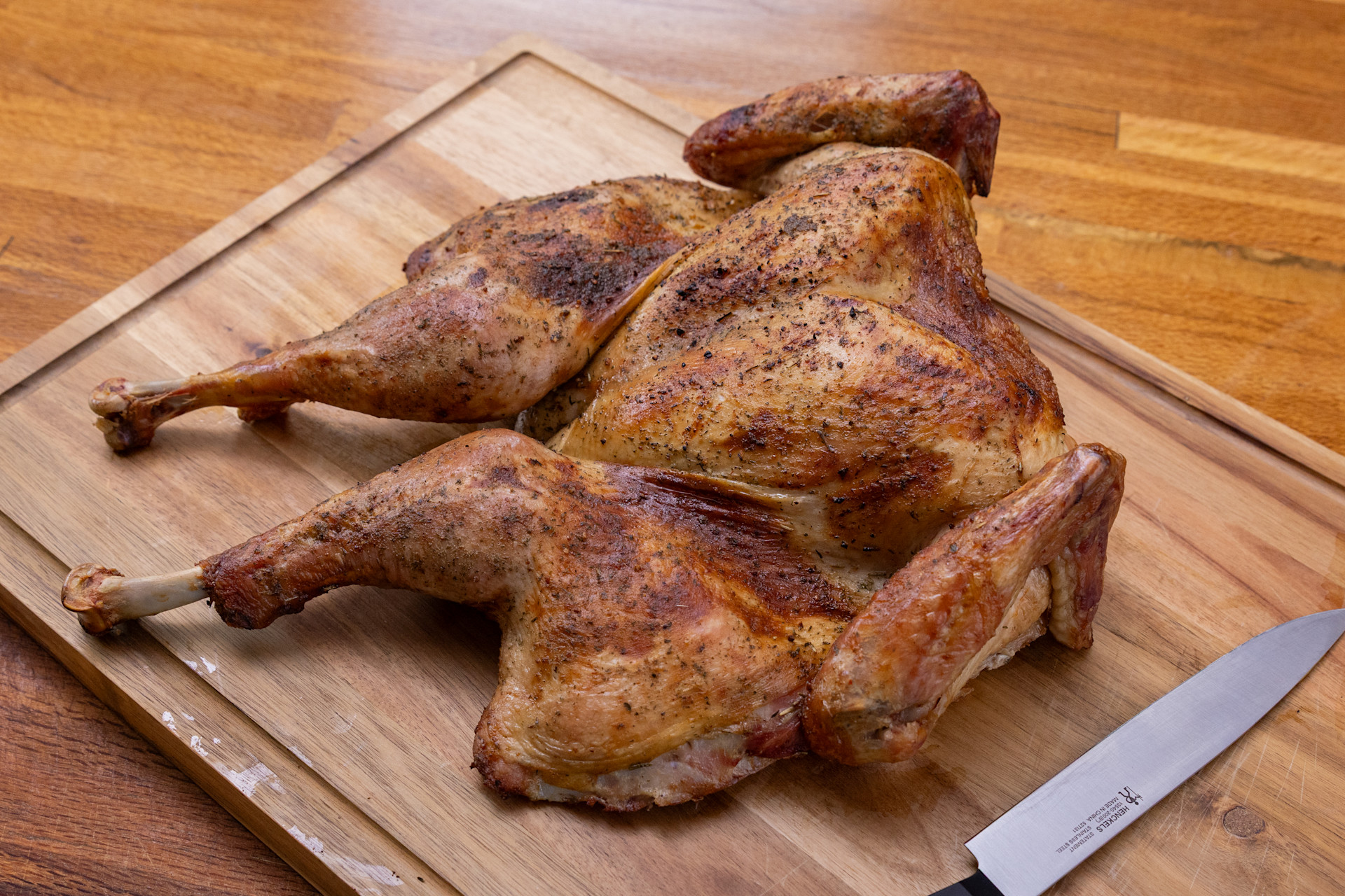 smoked whole turkey on a wood cutting board