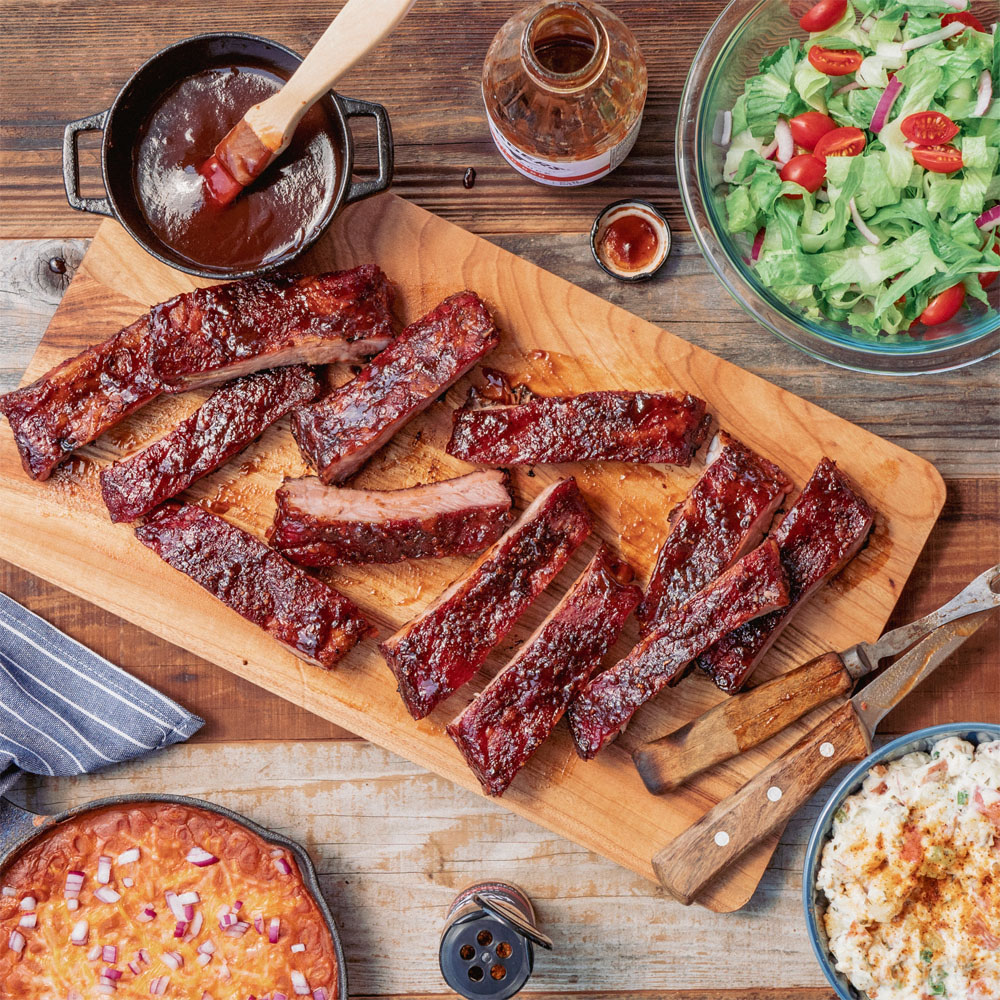 Pork ribs cut on a cutting board with sauce