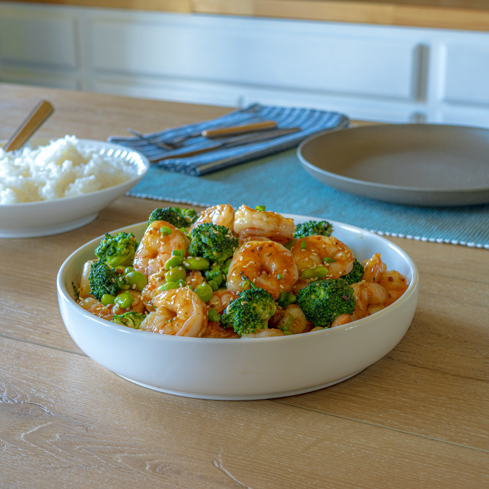 Stir fried shrimp in a white bowl