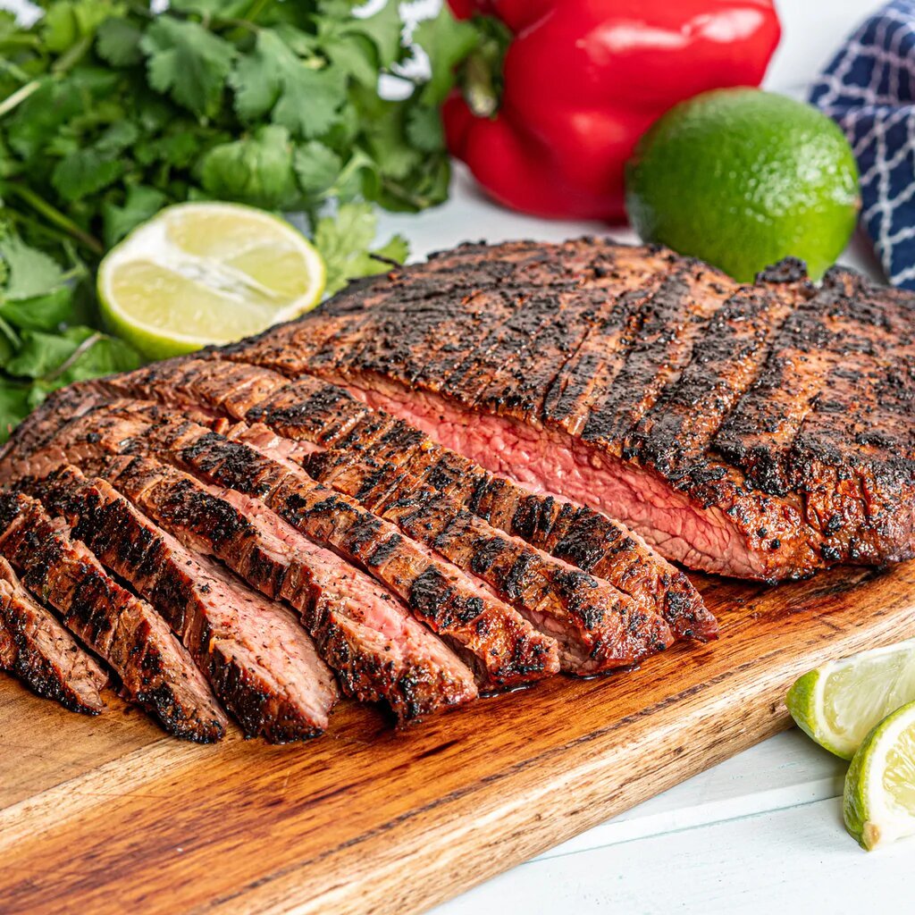 Photo of sliced carne asada on a cutting board