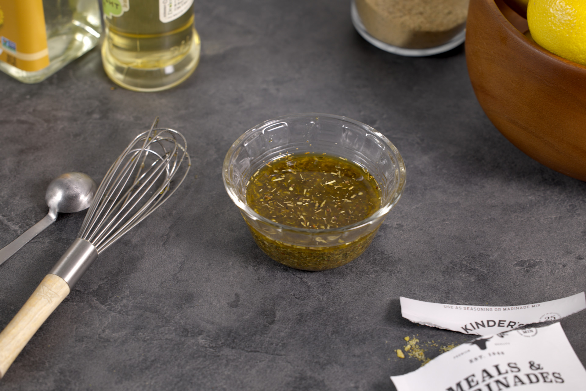 Garlic & Herb Marinade in a clear bowl with a whisk