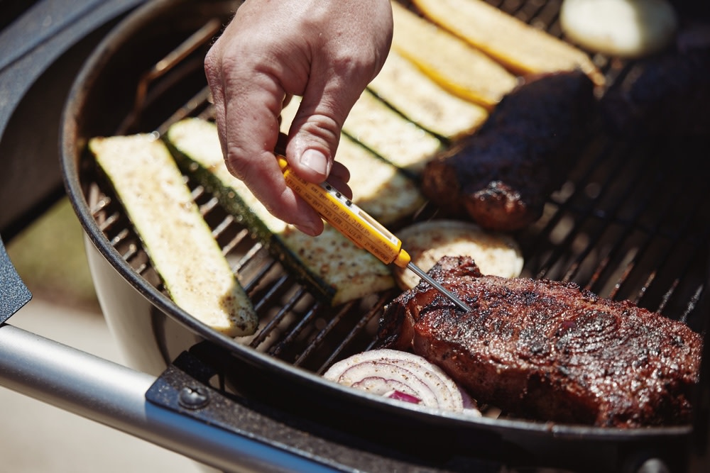 Checking meat temperature with an instant read thermometer