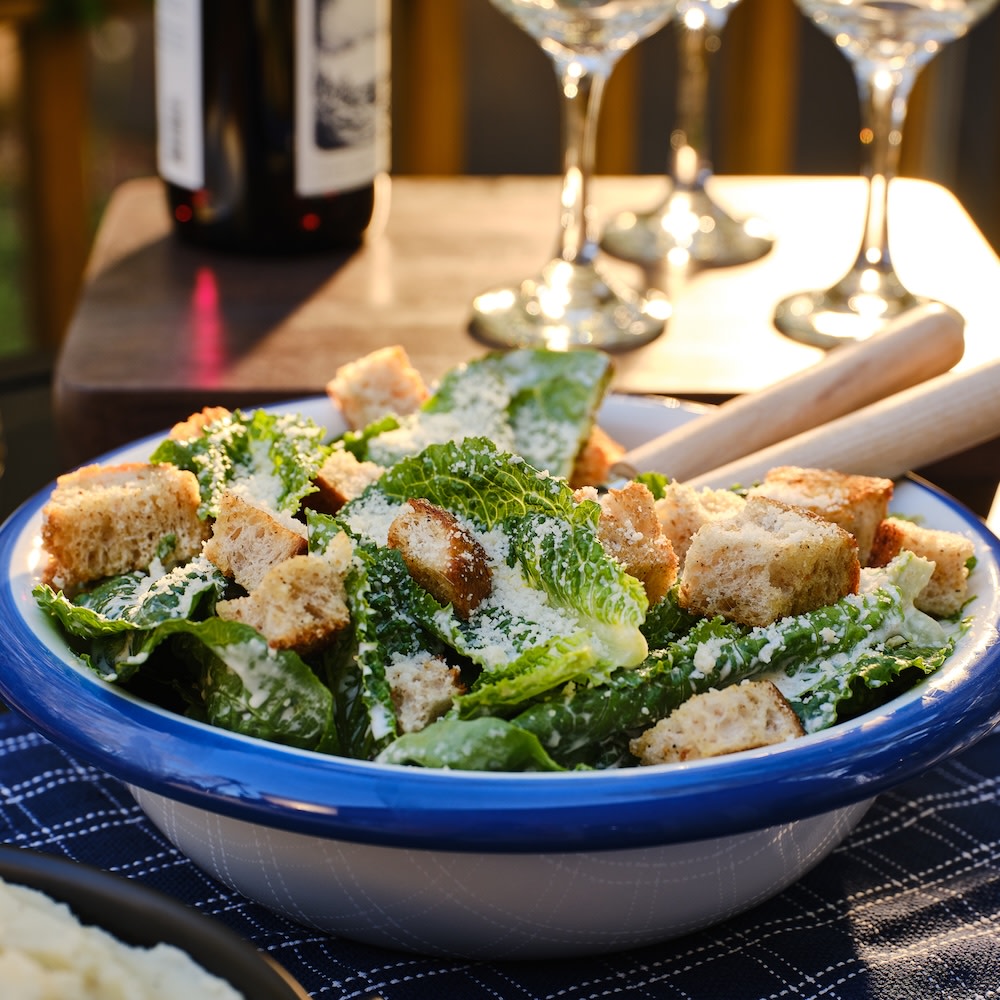 Caesar salad serving on a outdoor table