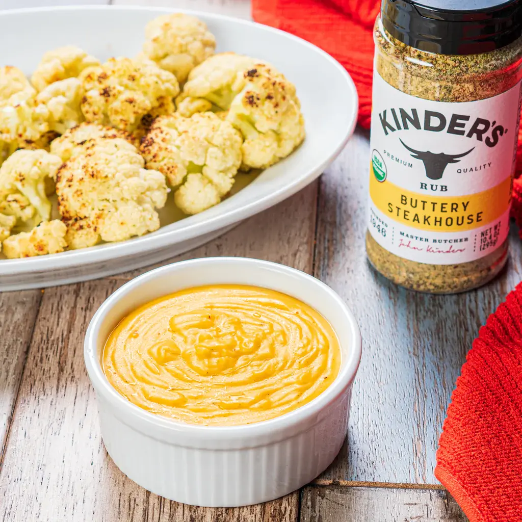 Roasted cauliflower with a bowl of cheese dip