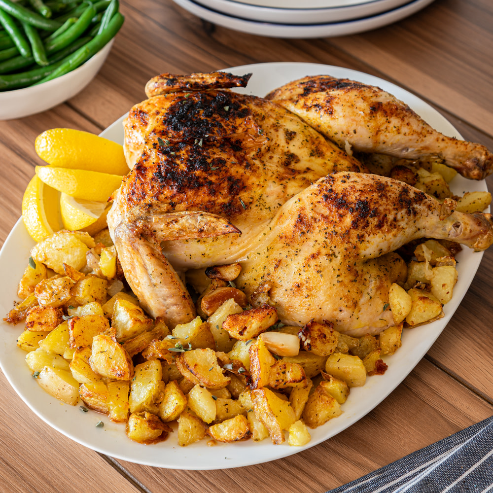 Oven roasted chicken with potatoes and lemon slices
