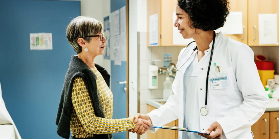 Incontinence patient shaking hand with a doctor