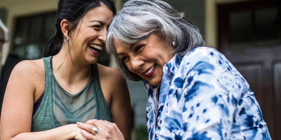 Two women smiling and laughing