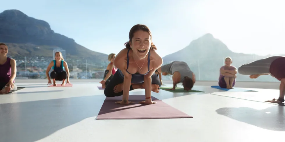 Woman smiling at outdoor yoga class