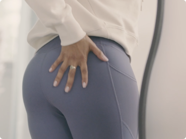 Backside of person wearing yoga pants and Always Discreet