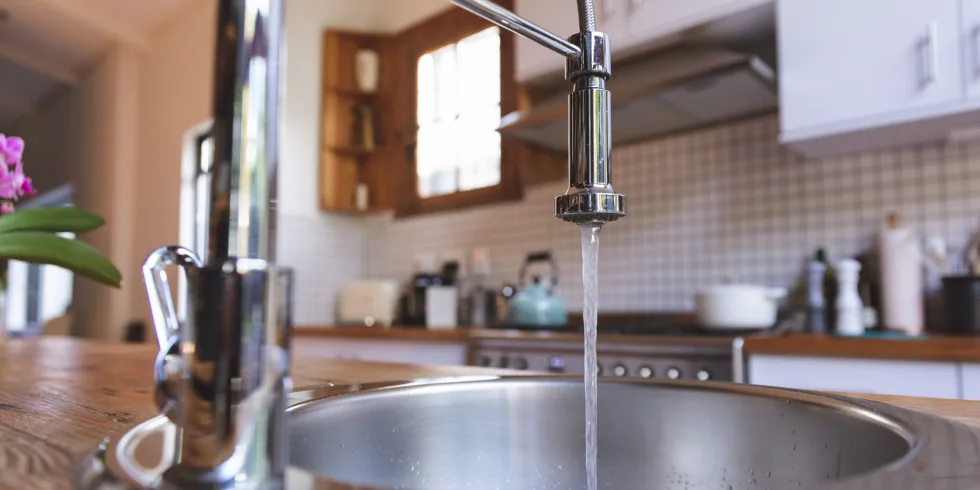 Close-up of faucet with water running