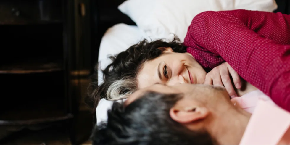 Couple on bed laughing