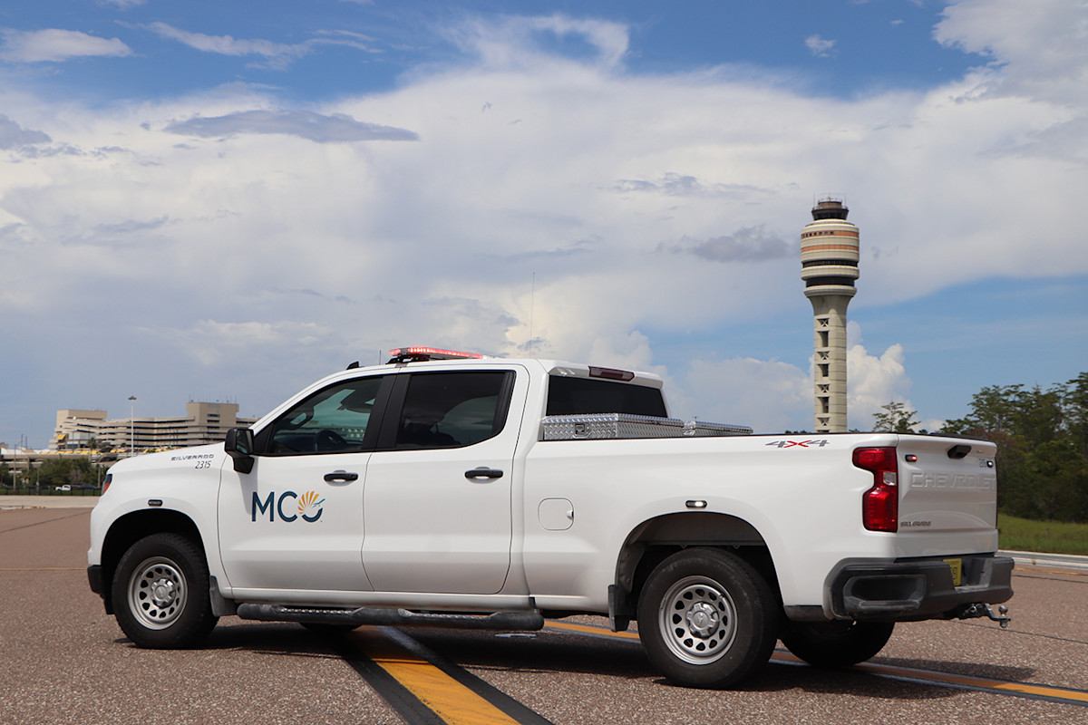 A white MCO Safety truck parked of the MCO control tower.