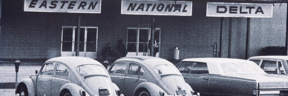 An old 1962 black and white photo of cars parked in front of old Terminal. Commercial air service starts relocation to McCoy AFB property (the future Orlando International Airport), 8 miles south of ORL.