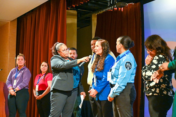 January 2024 Employee Recognition Brunch group photo of employees speaking.