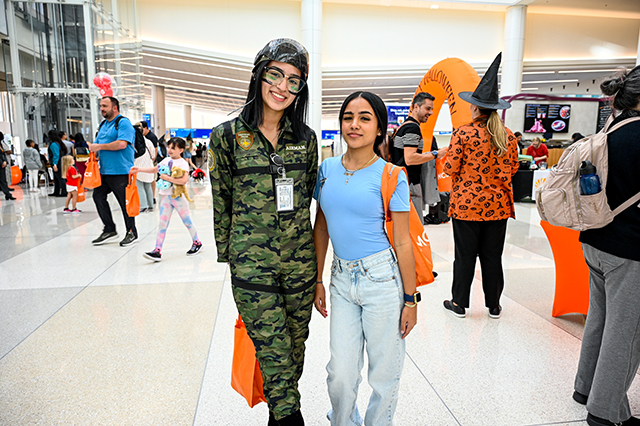 2025 Halloween at MCO photo of two ladies standing side by side. One is dressed up in army gear.