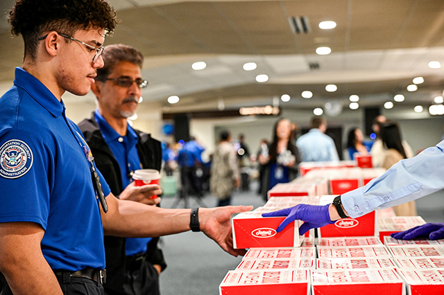 2025 Federal Airport Employee Appreciation Day photo of two federal TSA employees getting a free box lunch.