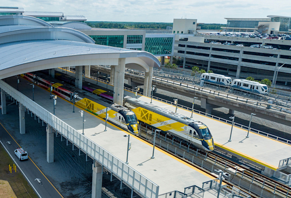 Aerial view of the MCO Brightline train station. Brightline trains waiting for people to board.