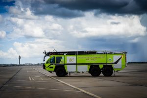 ARFF fire vehicle with GOAA tower in the background.