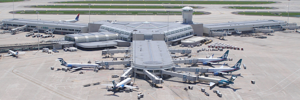 1990 aerial photo of MCO's gates 60 to 99 with planes parked.