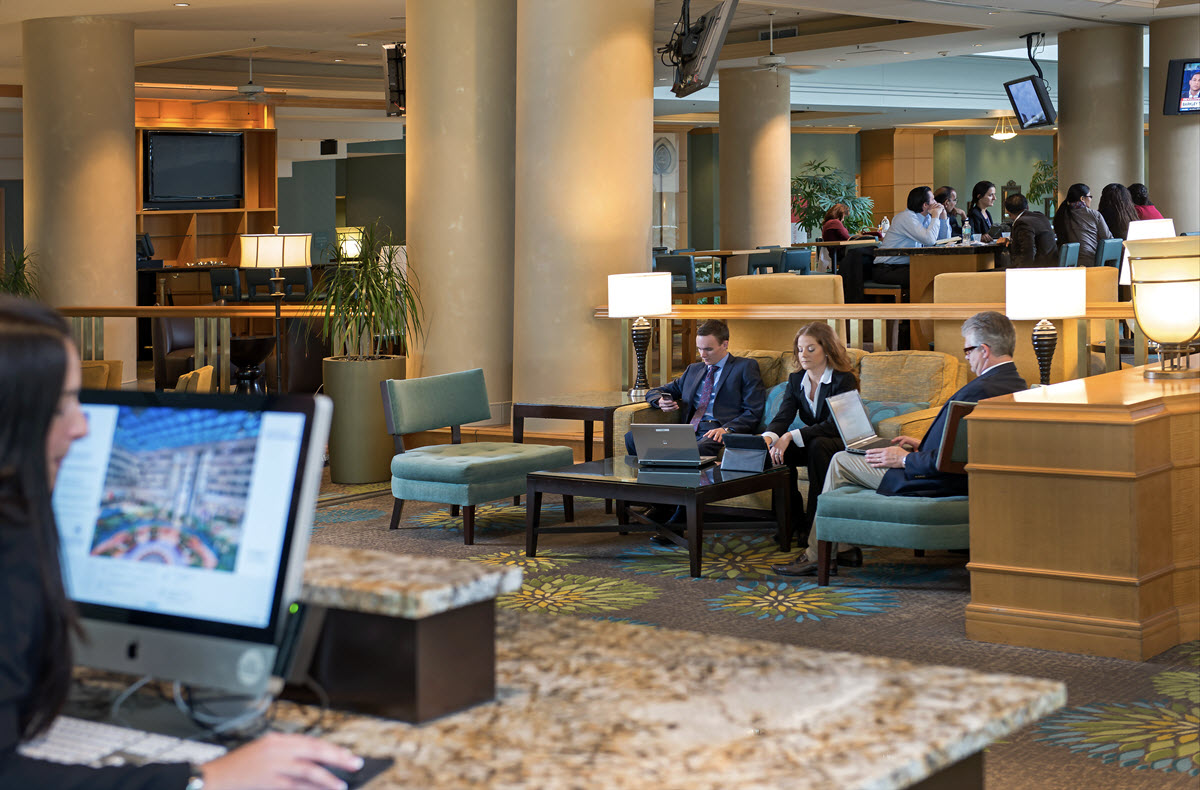 Three business people sitting in a hotel lobby