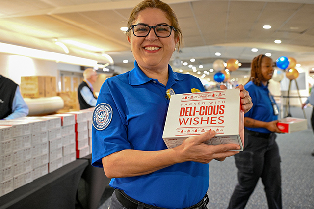 2025 Federal Airport Employee Appreciation Day photo of a federal TSA employee showing to the camera the box lunch they received.