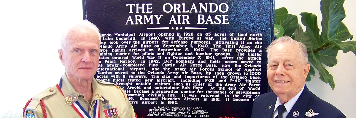 In 2010, two veterans stand in front of dedicated State Historical Marker, recognizing the contributions that the airport made in support of World War II. The marker is located at the northeast corner of the intersection of Maguire Blvd. and Livingston St. on the west side of the airport.