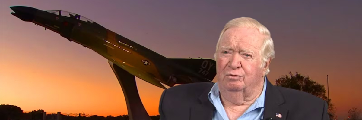 2013 photo of Col. Joe Kittinger standing of front an old US fight jet. 