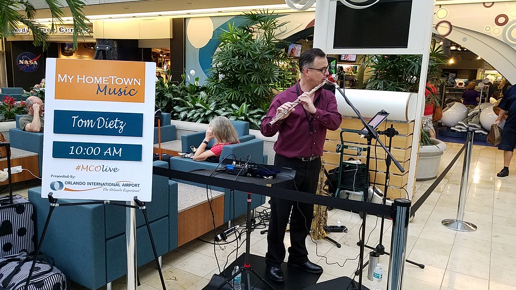 Tom Dietz May 2017 playing the flute in a terminal at MCO.