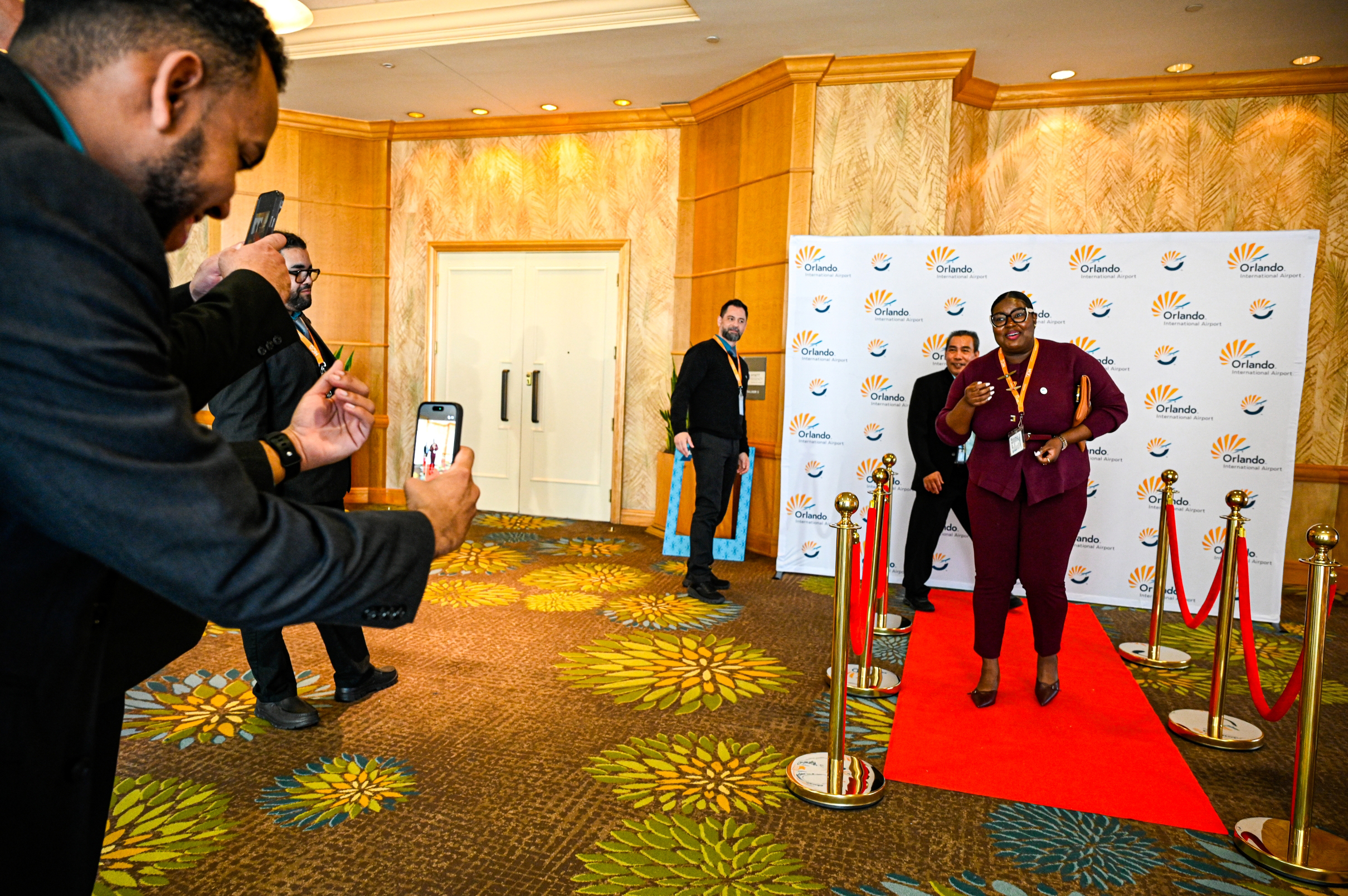 2025 Employee Recognition Brunch photo of an employee walking down a red carpet.