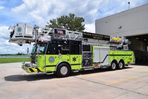 ARFF fire vehicle parked in front of a fire station.