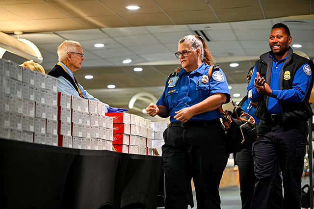 2025 Federal Airport Employee Appreciation Day photo of two federal TSA agents receiving a lunch box.