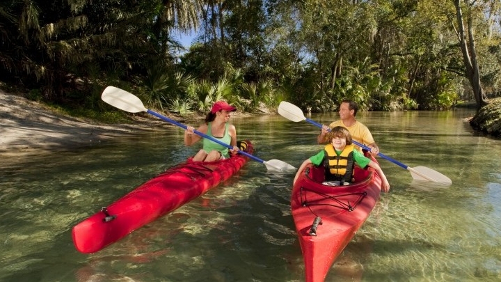 family kayaking towards med