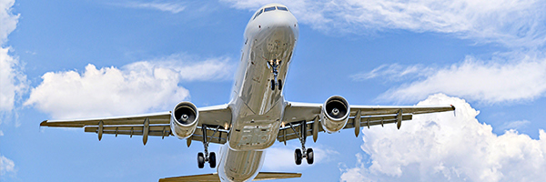 Plane taking off into the blue sky.