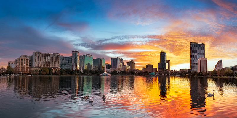 Sunset of Lake Eola with downtown Orlando in the background.