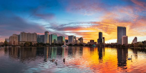 Sunset of Lake Eola with downtown Orlando in the background.