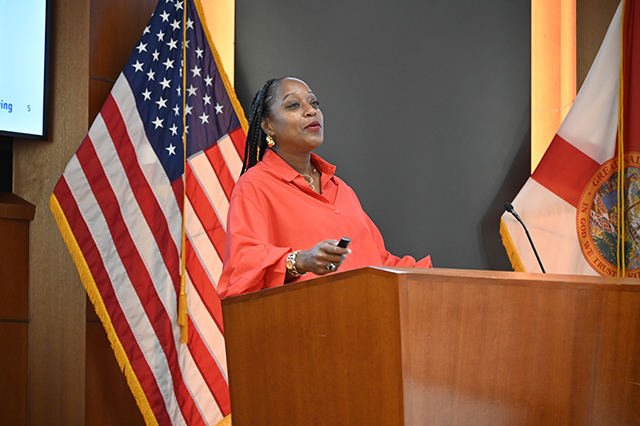 CSAC Culture Team - WORKSHOP Learn and Grow - Compassion Fatigue photo of speaker at a podium.