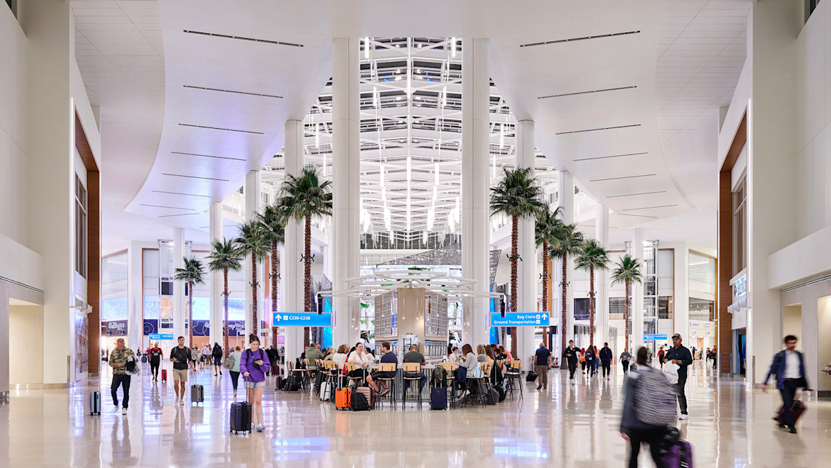 People walking around in Palm Court located in Terminal C at MCO.