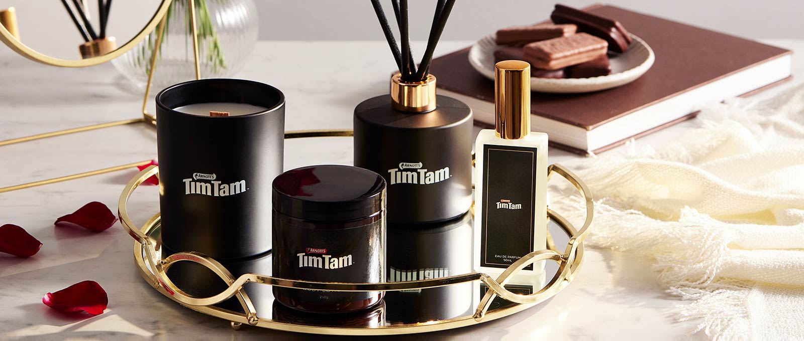 Carousel Image for Tim Tam merchandise range, including Tim Tam Candle, Tim Tam Perfume, Tim Tam Body Lotion