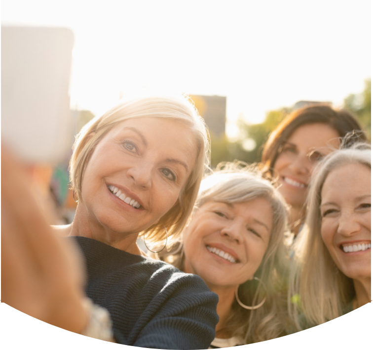 A group of smiling women taking a selfie