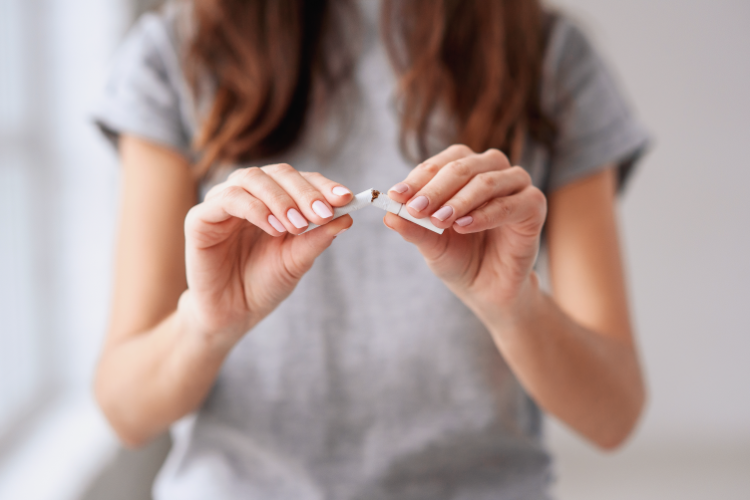 A woman breaking a cigarette